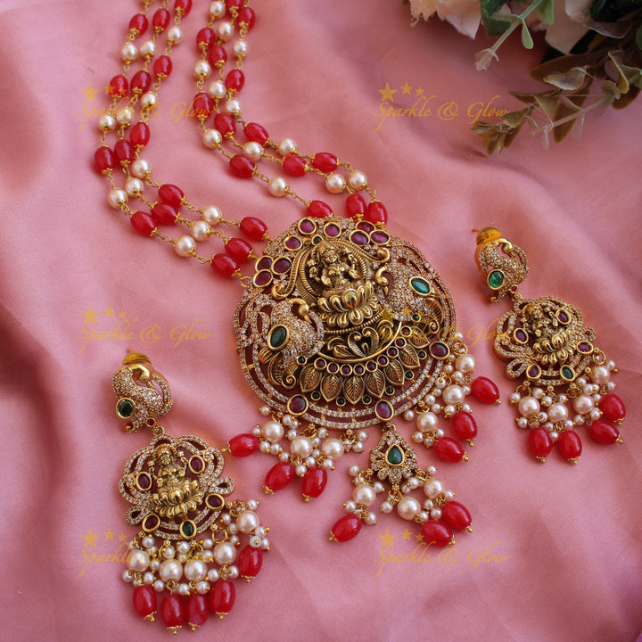 Beautiful Lakshmi peacock CZ stone pendant Victorian AD haram with three layer pearl and red beads chain