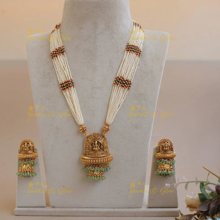Beautiful Lakshmi flower carved pendant haram with multi layer pearl chain and mint green beads - Sparkle and Glow