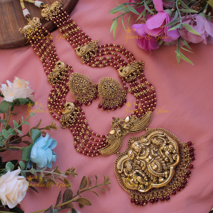 Gorgeous Krishna playing flute and peacock carved haram with multi layer gold and red beads chain