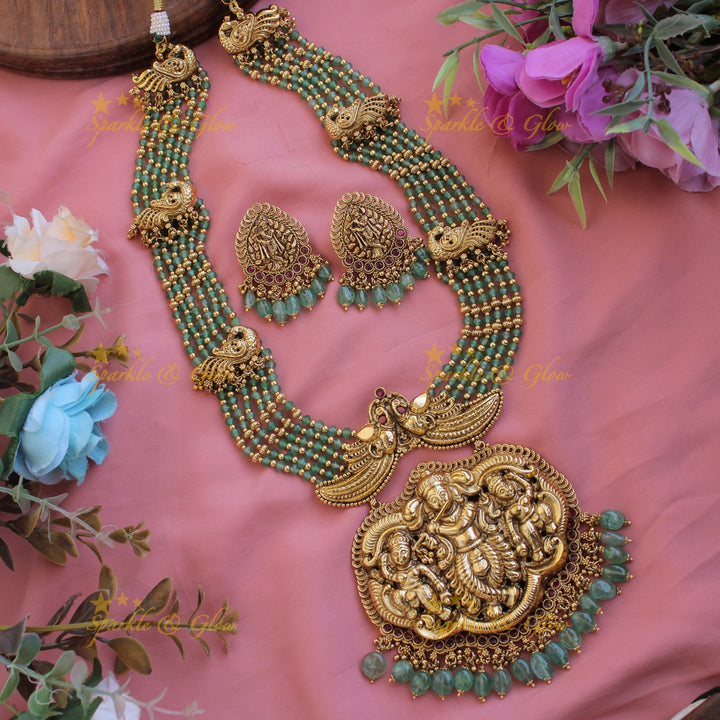 Gorgeous Krishna playing flute and peacock carved haram with multi layer gold and red beads chain