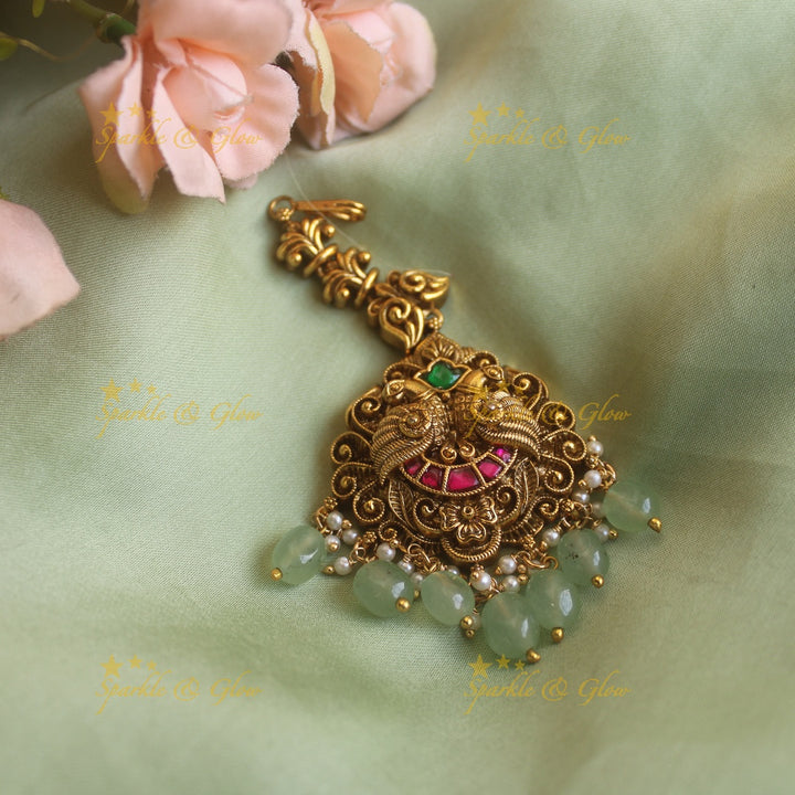 Statement Peacock carved jadau maang tikka with mint green beads