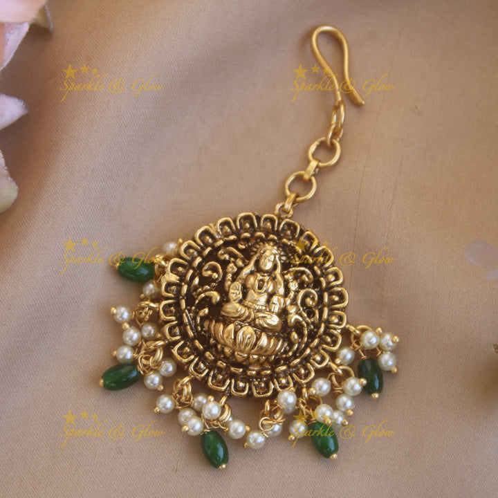 Stunning gold alike lakshmi maang tikka with green beads