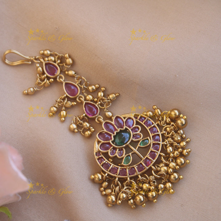 Beautiful gold alike floral designRed green stone with gold beads maang tikka