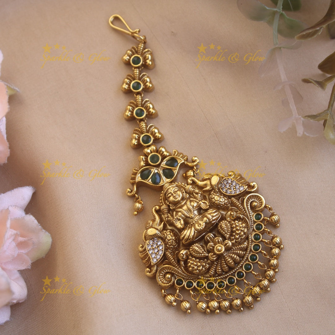 Exclusive gold alike lakshmi  with some AD and green stone and gold beads maang tikka