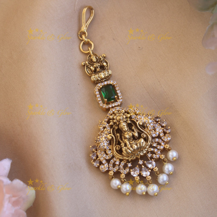 Beautiful Lakshmi flower carved maang tikka with ruby CZ stones and pearl drops