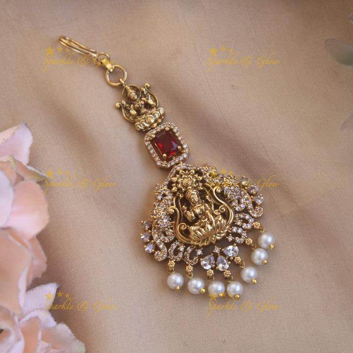 Beautiful Lakshmi flower carved maang tikka with ruby CZ stones and pearl drops