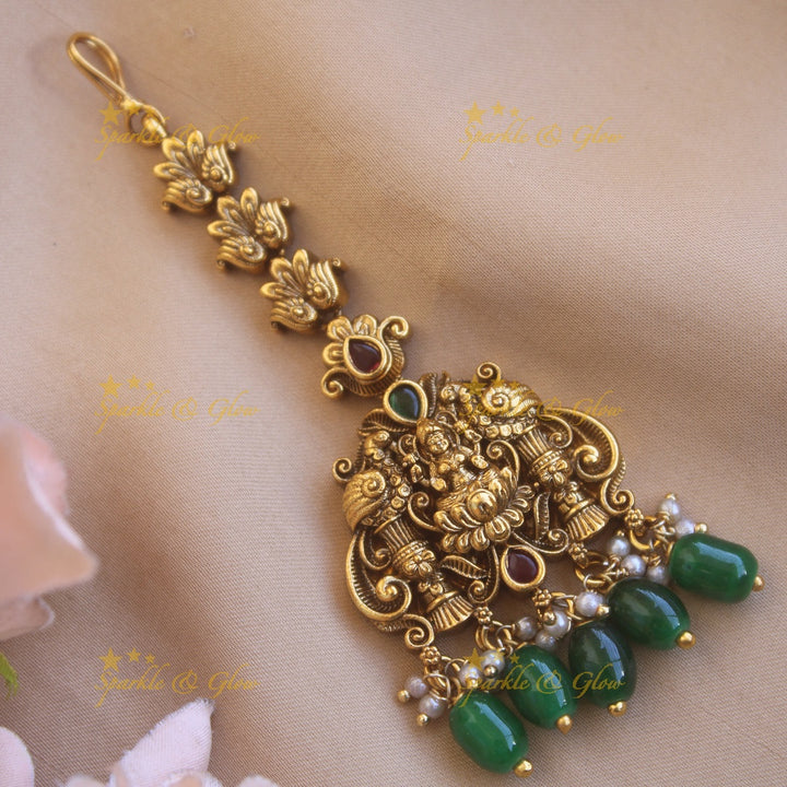 Gold alike Lakshmi peacock carved maang tikka with green beads