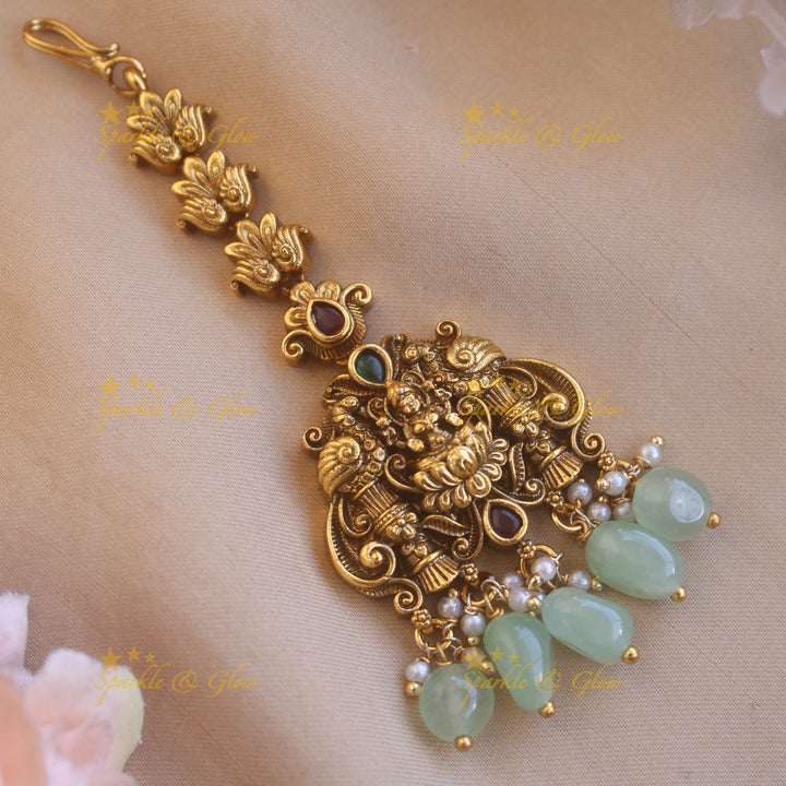 Gold alike Lakshmi peacock carved maang tikka with green beads