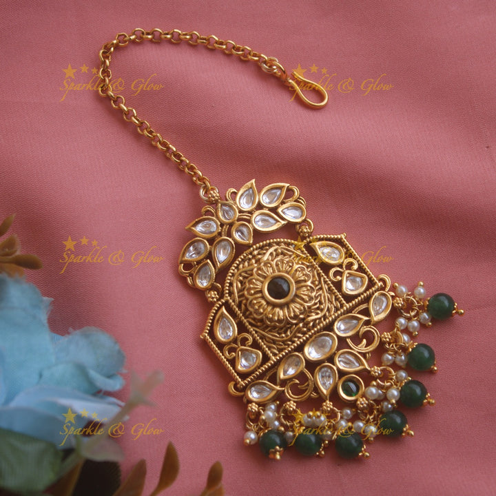 Grand floral leaf carved kundan maang tikka with pearls and green beads