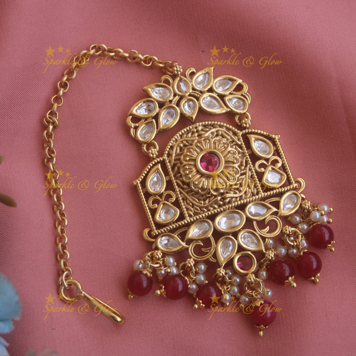 Grand floral leaf carved kundan maang tikka with pearls and green beads