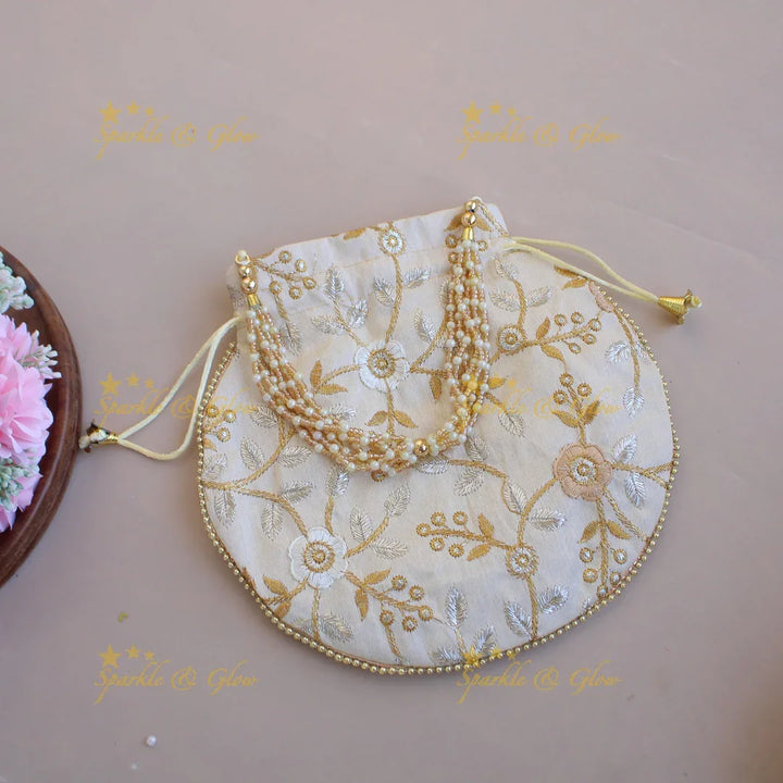 Floral Embroidered pot shape 8.5*8 inch potli bags with gold beads and pearl handle - Sparkle and Glow
