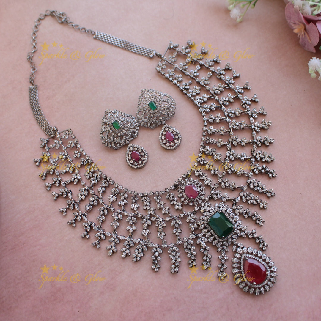 Glittering Three layer black finish American diamond short necklace with ruby and emerald stones - multi