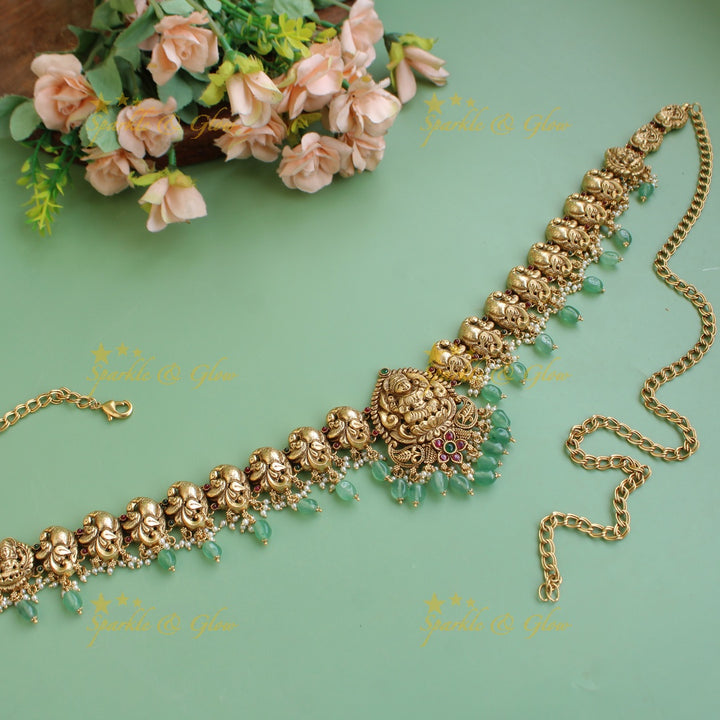 Elegant Lakshmi peacock carved hipchain with pearls and green beads