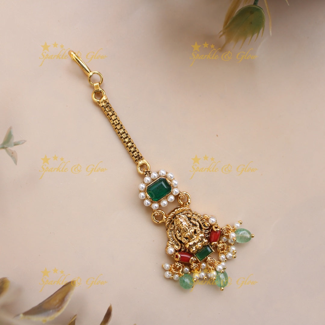 Beautiful Lakshmi maang tikka with coral pearls emerald and mint green beads