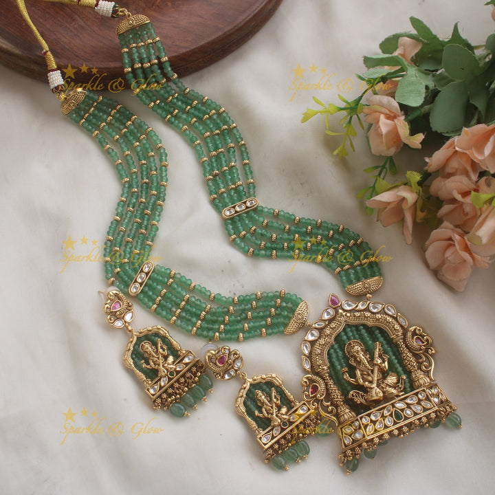 Exclusive Ganesha carved pendant haram with kundan stones and multi layer pearl and gold beads chain