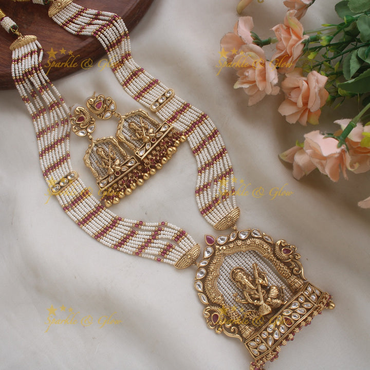 Exclusive Ganesha carved pendant haram with kundan stones and multi layer pearl and gold beads chain