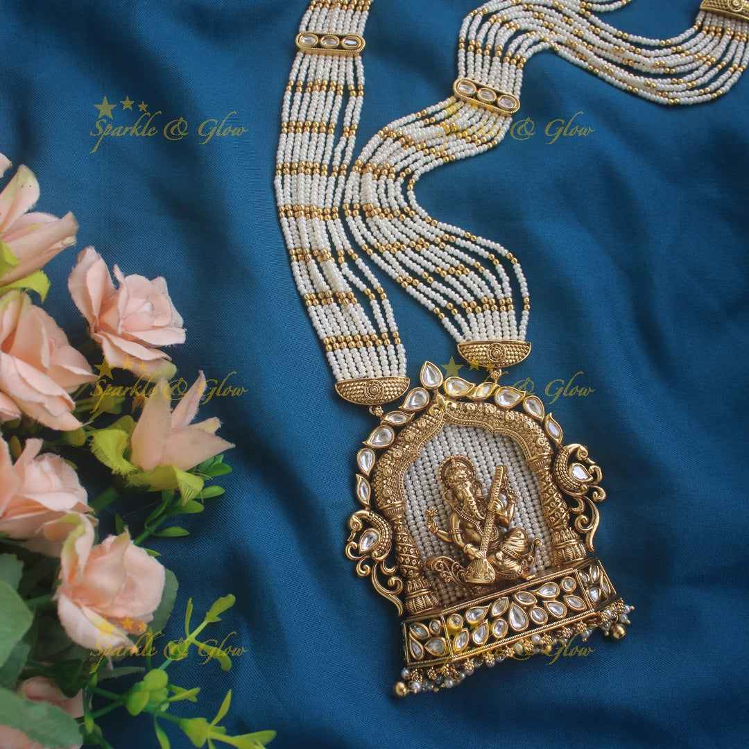 Exclusive Ganesha carved pendant haram with kundan stones and multi layer pearl and gold beads chain