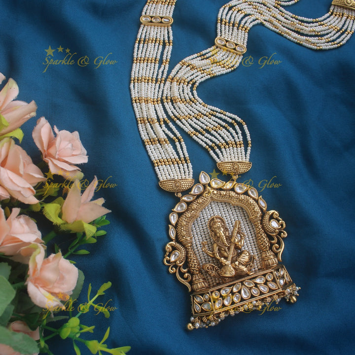 Exclusive Ganesha carved pendant haram with kundan stones and multi layer pearl and gold beads chain