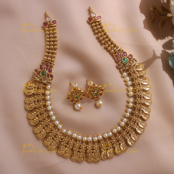 Gold alike Lakshmi coin and floral design AD short necklace with ruby emerald and pearls