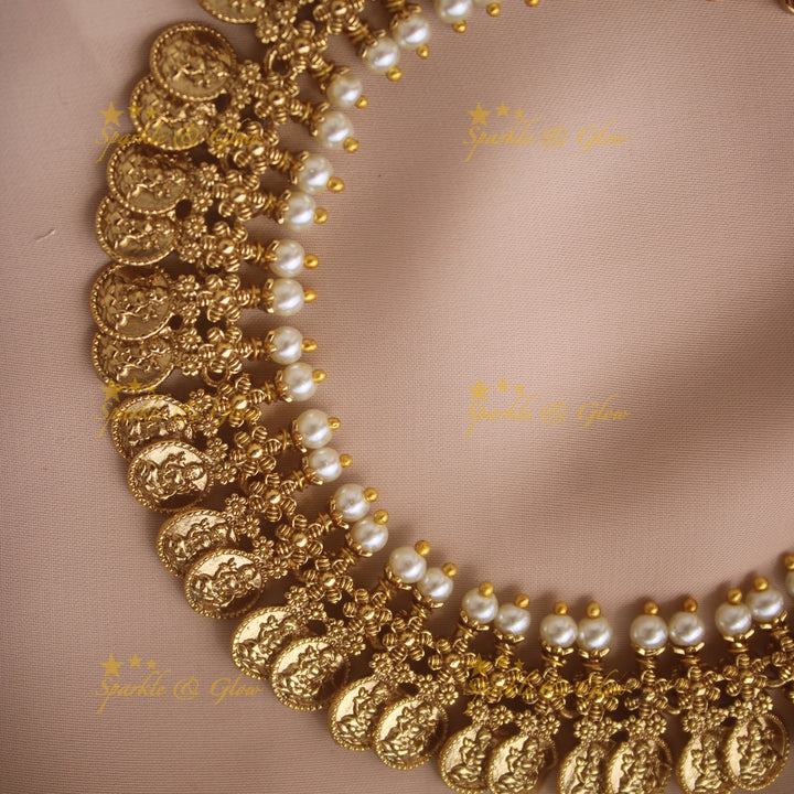 Gold alike Lakshmi coin and floral design AD short necklace with ruby emerald and pearls
