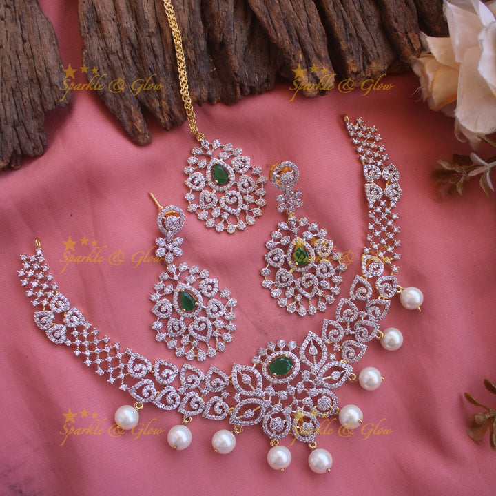 Elegant Floral Leaflet design American diamond short necklace with emerald and pearl drops with maang tikka- pink