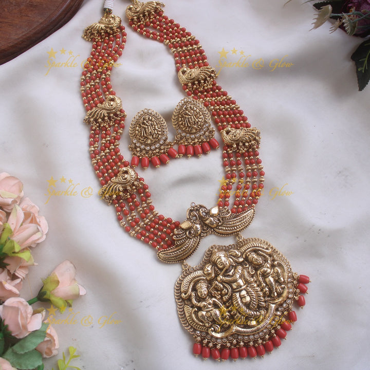 Gorgeous Krishna playing flute and peacock carved haram with multi layer gold and red beads chain