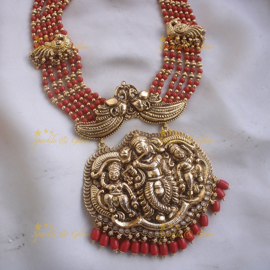 Gorgeous Krishna playing flute and peacock carved haram with multi layer gold and red beads chain - Sparkle and Glow - Back Thread - 