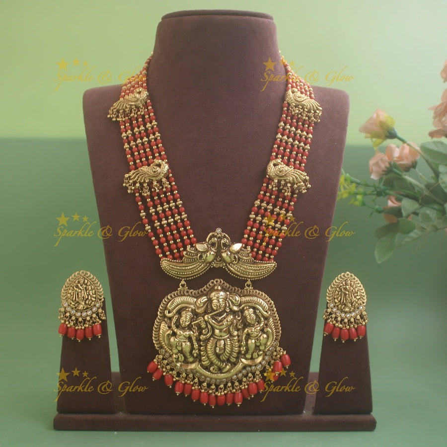 Gorgeous Krishna playing flute and peacock carved haram with multi layer gold and red beads chain - Sparkle and Glow - Back Thread - 