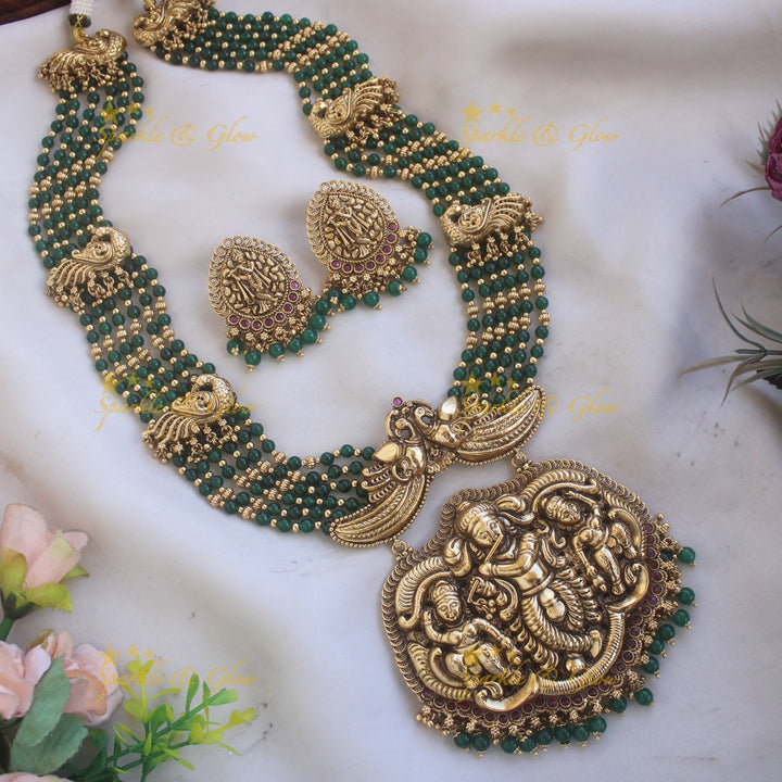 Gorgeous Krishna playing flute and peacock carved haram with multi layer gold and red beads chain