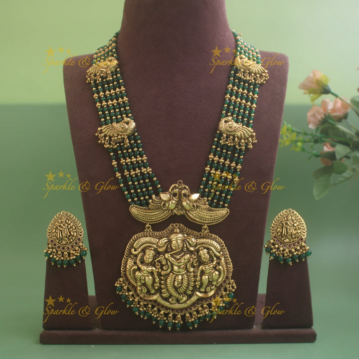 Gorgeous Krishna playing flute and peacock carved haram with multi layer gold and red beads chain