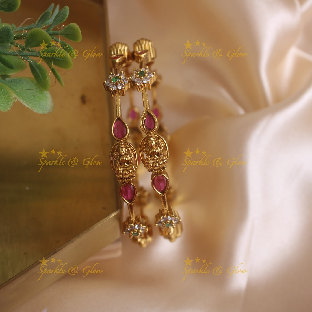 Statement Lakshmi and floral design bangles with ruby emerald and white stones, a pair , 2.4