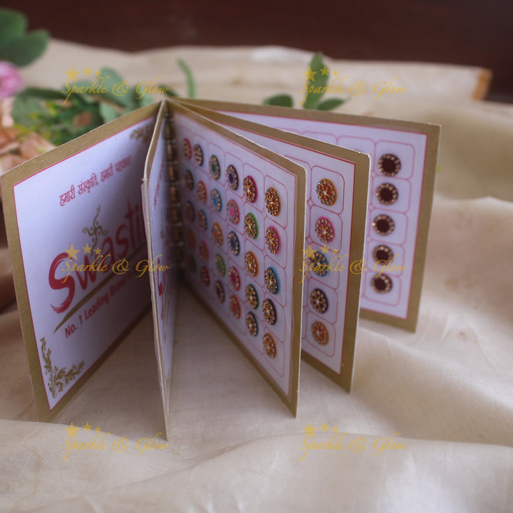 Swastik round stone silver and gold design bindi with single size in spiral book in assorted colours