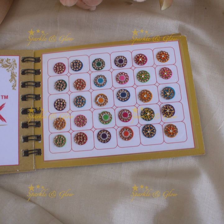 Swastik round stone silver and gold design bindi with single size in spiral book in assorted colours