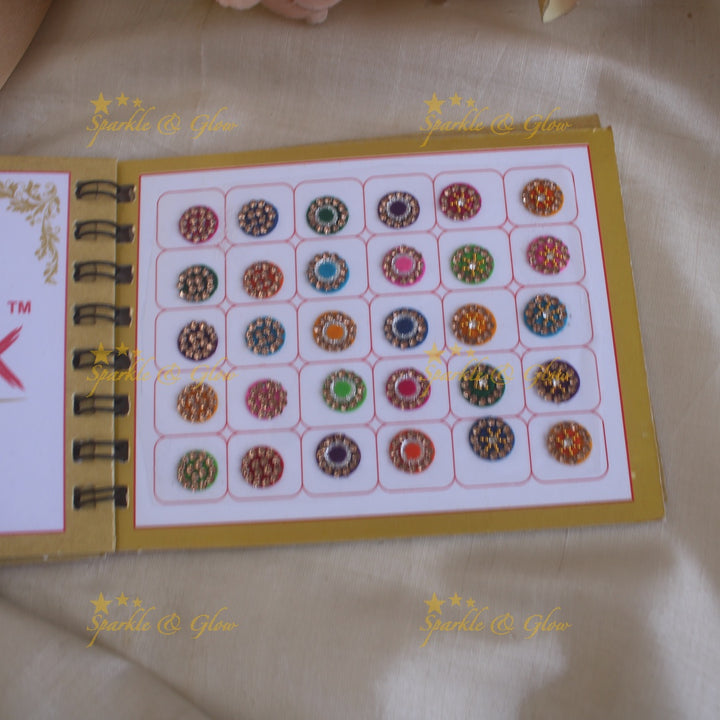 Swastik round stone silver and gold design bindi with single size in spiral book in assorted colours