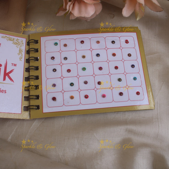 Swastik round single stone bindi with in spiral book in assorted colours