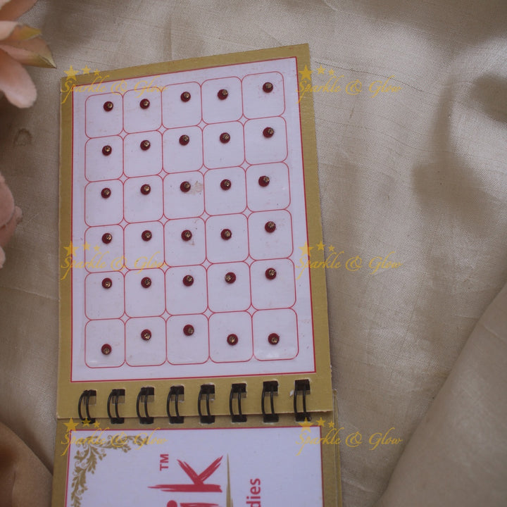 Swastik round single stone bindi with in spiral book in assorted colours