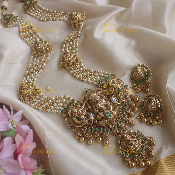 Stunning Lakshmi peacock pendant haram with multi layer pearl and gold beads chain with emerald stones - gold - Sparkle and Glow