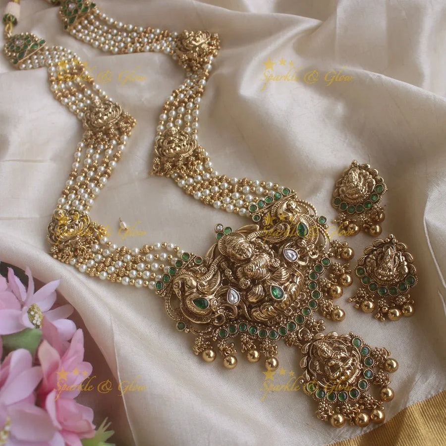 Stunning Lakshmi peacock pendant haram with multi layer pearl and gold beads chain with emerald stones - gold - Sparkle and Glow