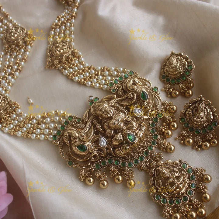Stunning Lakshmi peacock pendant haram with multi layer pearl and gold beads chain with emerald stones - gold - Sparkle and Glow