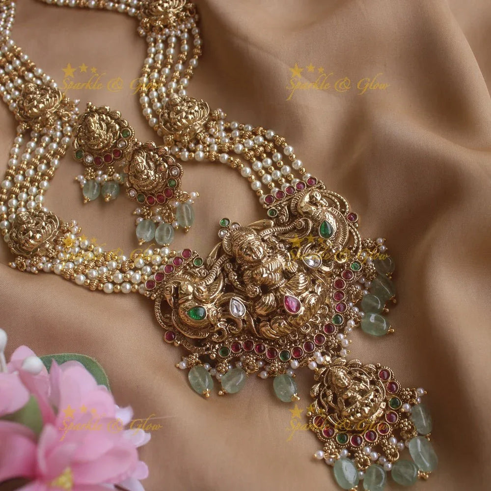 Stunning Lakshmi peacock pendant haram with multi layer pearl and gold beads chain with emerald stones - gold - Sparkle and Glow