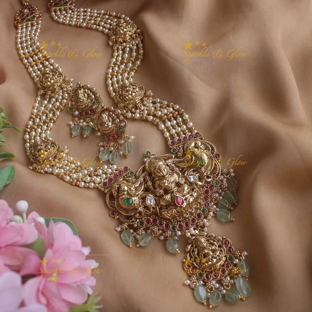 Stunning Lakshmi peacock pendant haram with multi layer pearl and gold beads chain with emerald stones - gold - Sparkle and Glow