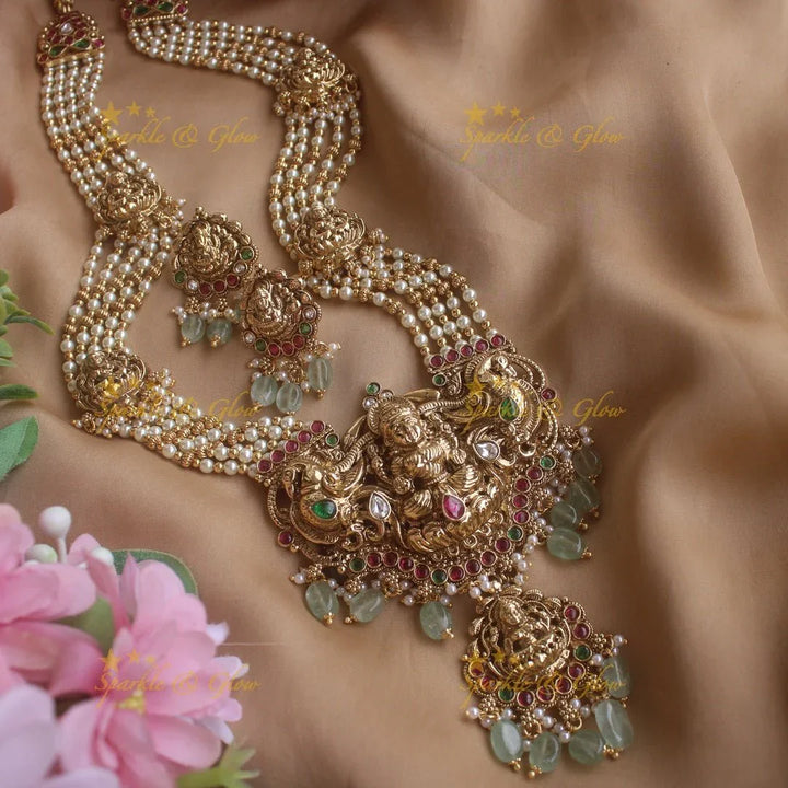 Stunning Lakshmi peacock pendant haram with multi layer pearl and gold beads chain with emerald stones - gold - Sparkle and Glow