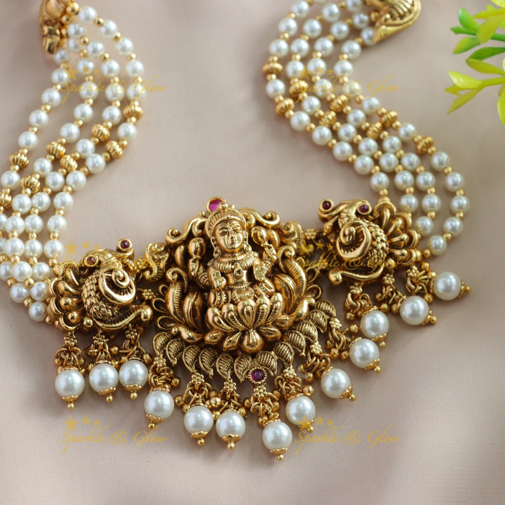 Elegant Lakshmi Peacock carved choker with multi layer pearl and pearl drops