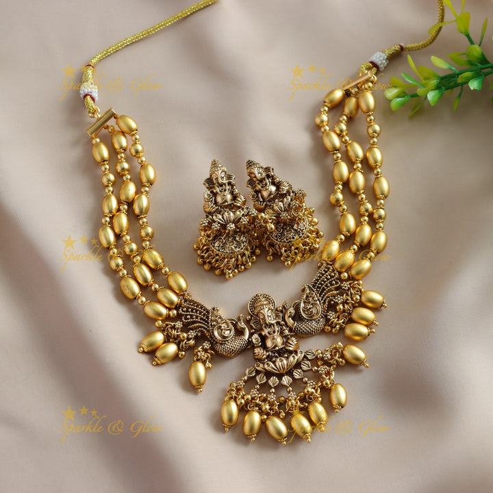 Beautiful Ganesha peacock carved high neck choker with multi layer gold beads