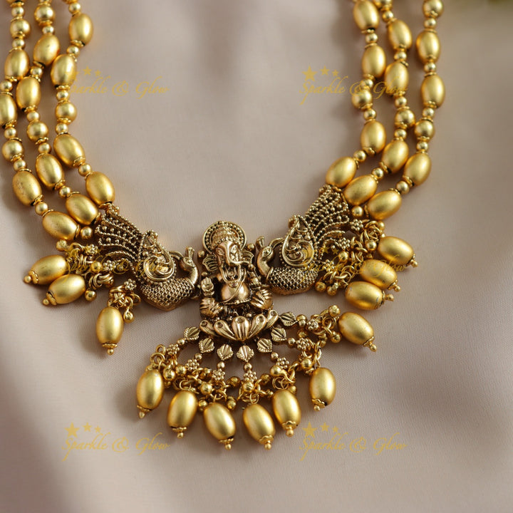 Beautiful Ganesha peacock carved high neck choker with multi layer gold beads