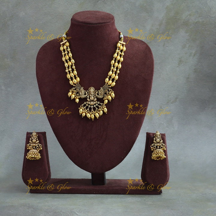 Beautiful Ganesha peacock carved high neck choker with multi layer gold beads