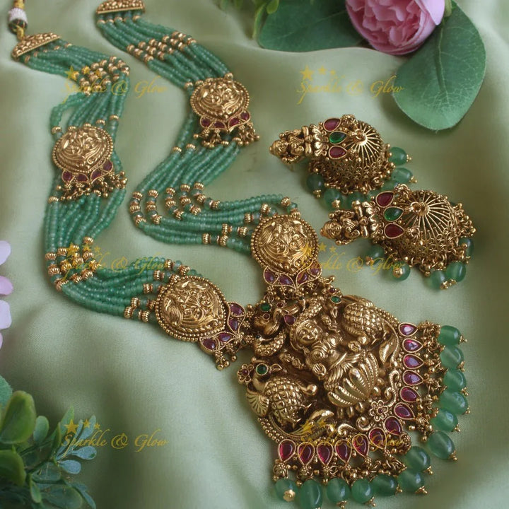 Exclusive Lakshmi peacock carved pendant haram with multi layer gold and mint green beads chain and ruby stones - Sparkle and Glow