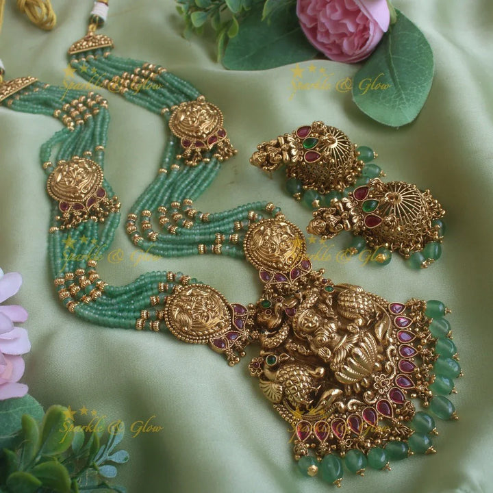 Exclusive Lakshmi peacock carved pendant haram with multi layer gold and mint green beads chain and ruby stones - Sparkle and Glow