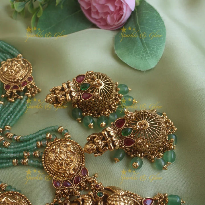Exclusive Lakshmi peacock carved pendant haram with multi layer gold and mint green beads chain and ruby stones - Sparkle and Glow