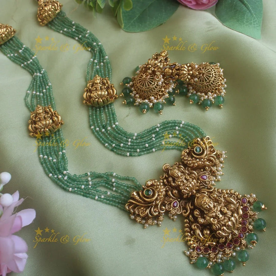 Gorgeous Lakshmi peacock carved pendant haram with multi layer mint green beads chain ruby stones and pearls - Sparkle and Glow
